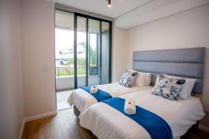 a bedroom with two beds with towels on them at 108 The Meadows in George +25 photos