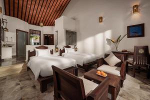 Voodi või voodid majutusasutuse Legacy Hoi An Resort toas