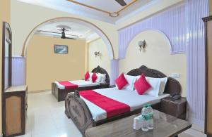 a hotel room with two beds and a table at Hotel Ashoka Continental in New Delhi +39 photos