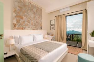 a bedroom with a bed and a large window at W15 Ambuluwawa in Gampola