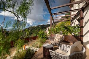 a balcony with chairs and a view of the mountains at Tenuta Zamparina in Montignoso