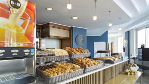 a bakery with many baskets of bread and pastries at B&B Hotel Pescara in Pescara +26 photos