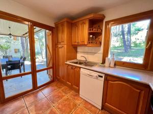 a kitchen with wooden cabinets and a counter top at Villa Zocotin in Villanúa +60 photos