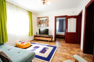 a living room with a couch and a television at Villa Misli - Heart of Dalyan and Newly Renovated in Dalyan