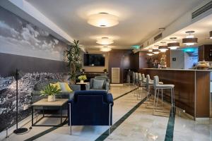 a waiting room with chairs and a bar at Catalonia Atenas in Barcelona