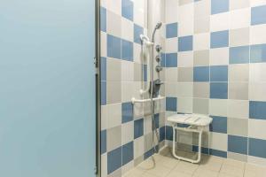 a bathroom with a shower with a toilet at Centre International de Séjour in Laval +26 photos