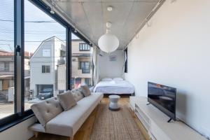 a living room with a couch and a bed at trias527 2-4 in Tokyo