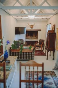 a living room with a couch and a fireplace at San Gabriel Homestead in Somerset West