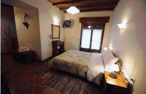 a hotel room with a bed and a window at Morfeas in Karpenisi