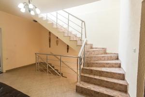 a staircase in a house with a metal railing at Rooms and Apartments Milana in Bar