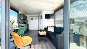 a living room with a couch and a table at Golfzicht by Droomvilla in Uitgeest +13 photos