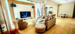 a living room with a couch and a tv at Austin Leisurely villa in Johor Bahru