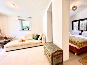 a living room with a couch and a bed at Domus Orestea Luxury Suites in Palermo