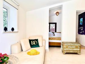 a living room with a couch and a bed at Domus Orestea Luxury Suites in Palermo