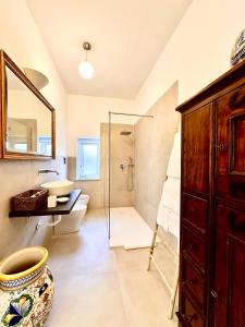 a bathroom with a sink and a toilet and a shower at Domus Orestea Luxury Suites in Palermo