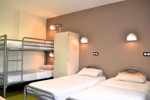a room with three bunk beds in a dorm at Centre International de Séjour in Laval