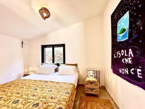 a bedroom with a bed and a poster on the wall at Domus Orestea Luxury Suites in Palermo