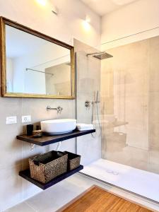 a bathroom with a sink and a shower with a mirror at Domus Orestea Luxury Suites in Palermo