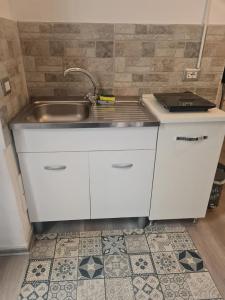 a kitchen counter with a sink and a sink at Casa Lucia Ortigia in Syracuse +11 photos