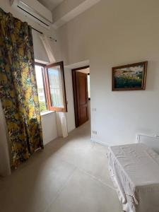 a bedroom with a bed and a painting on the wall at Domus Orestea Luxury Suites in Palermo