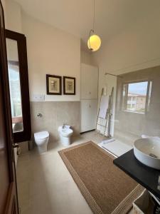 a bathroom with a toilet and a sink at Domus Orestea Luxury Suites in Palermo