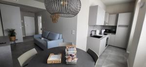 a kitchen and living room with a table and a couch at Casa Ilenia Clusane d'Iseo in Clusane sul Lago