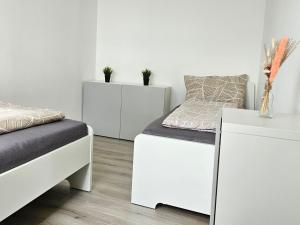 Ένα ή περισσότερα κρεβάτια σε δωμάτιο στο City Apartment in Eppelheim near Heidelberg