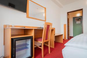 Postel nebo postele na pokoji v ubytování Hotel Globus