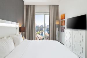 a hotel room with a large bed and a large window at The First Collection Dubai Marina in Dubai