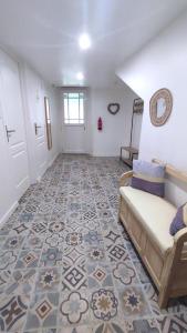 a living room with a couch and a tile floor at O naturel in Buzancy