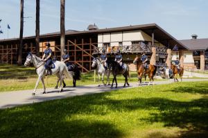 a group of police officers riding horses down a road at Royal Horse Resort in Balkasodis +26 photos