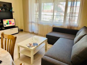 a living room with a couch and a table at Beach Apartments Pomorie in Pomorie