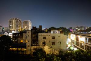 a view of a city at night with buildings at Myestay Elite The Ultimate Luxury Spacious Villa in Varanasi