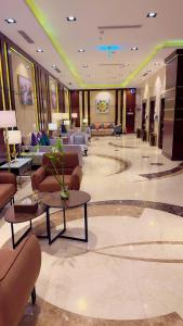 a lobby with couches and tables in a hotel at Skoop Jeddah in Jeddah