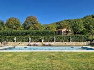 a swimming pool in a yard with chairs and a building at Villa Ginori 1755 in Londa