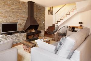 a living room with a couch and a fireplace at Stadium by FeelFree Rentals in Gessa
