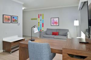 a living room with a table and a couch at Hampton Inn & Suites Greenville in Greenville