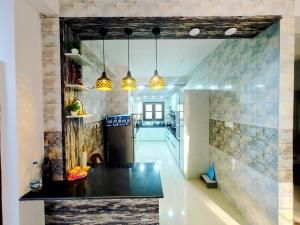 a kitchen with a black counter top in a room at Whispering Meadows in Shimla