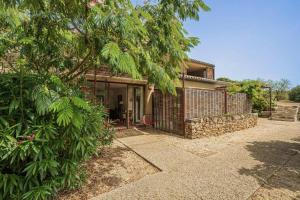 a house with a stone fence and a tree at Louis Henry in Saint-Pierre-des-Champs +28 photos