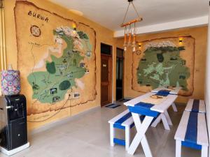 a room with a table and a map on the wall at The Bunker Burwa Manali in Manāli