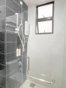 a bathroom with a shower with a glass door at 1min to Paradigm Mall 2to 5pax Platino MujiStyle in Johor Bahru +12 photos
