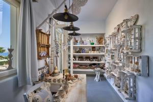 a room filled with lots of shelves filled with figurines at Althea Boutique Hotel - Adults Only in Amoopi