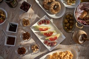 a table topped with plates of different types of food at Althea Boutique Hotel - Adults Only in Amoopi