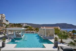 a pool at a resort with a view of the ocean at Althea Boutique Hotel - Adults Only in Amoopi