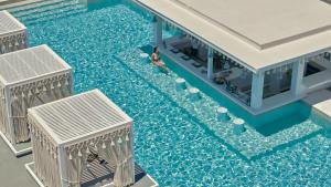 an overhead view of a swimming pool with two people in the water at Althea Boutique Hotel - Adults Only in Amoopi