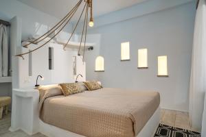 a bedroom with a bed in a white room at Althea Boutique Hotel - Adults Only in Amoopi