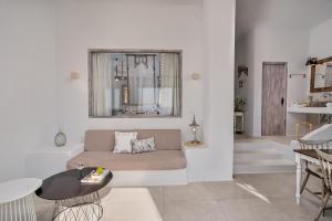 a living room with a couch and a table at Althea Boutique Hotel - Adults Only in Amoopi