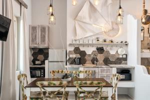 a kitchen with a wooden table and chairs at Althea Boutique Hotel - Adults Only in Amoopi
