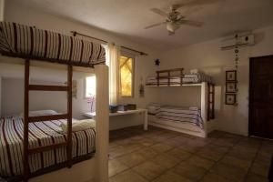 a bedroom with two bunk beds and a window at Monterrico Resort in La Candelaria +7 photos