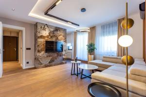 a living room with a couch and a fireplace at The Residence 59 in Belgrade